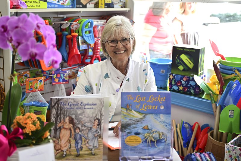 Ilona Holland sits ready to autograph her books.