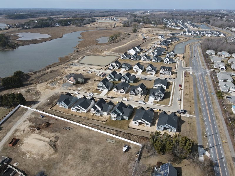 An aerial view of Osprey Point from February. On the left is the land along Arnell Creek where a proposed marina, kayak launch and bulkhead community beach would be built. NVR is suing the developer, demanding they build the amenities. NICK ROTH PHOTO