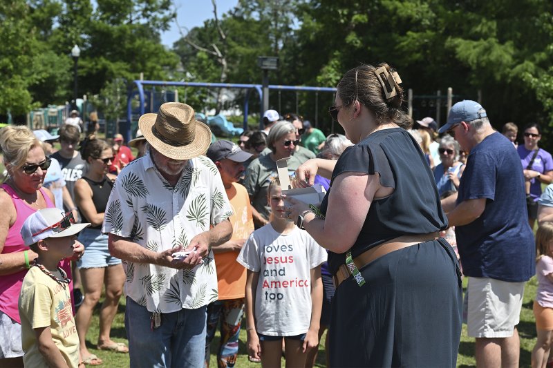 Skyler Bayko of Cancer Support Community of Delaware distributes live butterflies to participants. TED PFIRRMANN PHOTOS