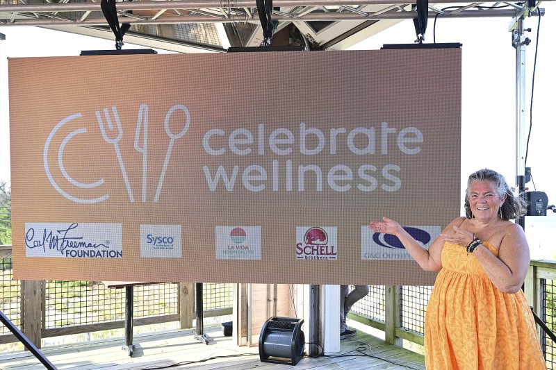 Kathy McDonald, director of development for Celebrate Wellness, welcomes everyone to the Orange Party at Big Chill Beach Club. TED PFIRRMANN PHOTOS