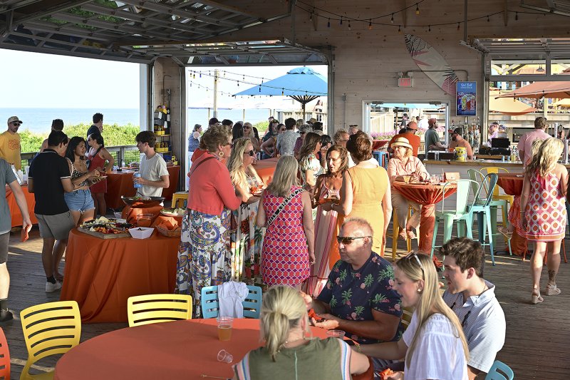 The crowd mingles as the evening wears on.