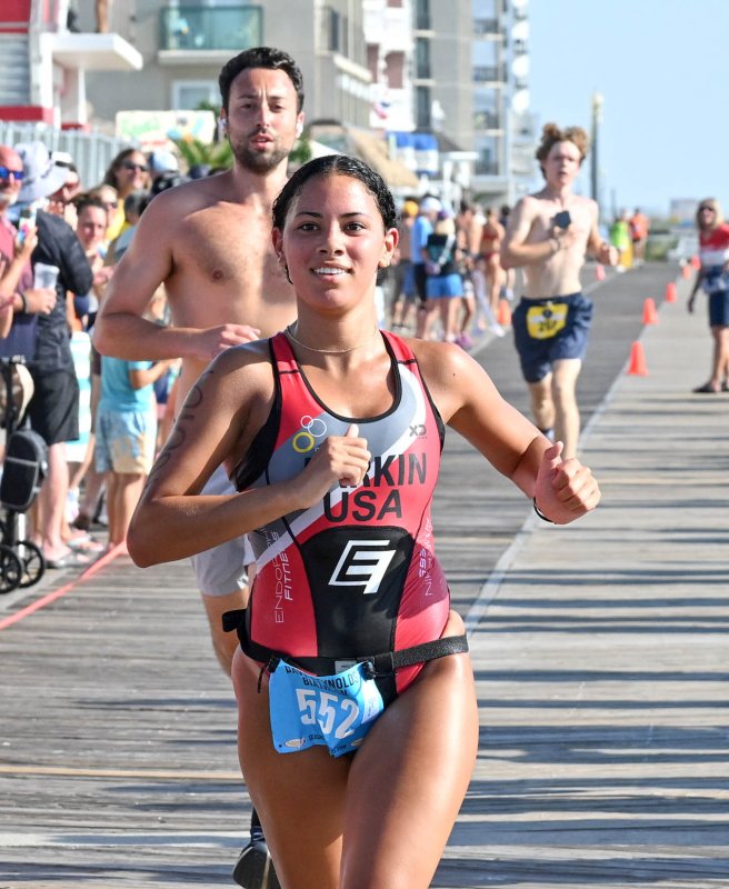 Female overall winner Ava Larkin crosses the finish line in 33.33.5.
