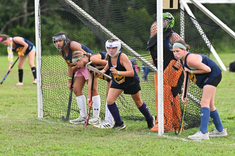 The Blue team’s defense storms from the goal during a penalty corner.