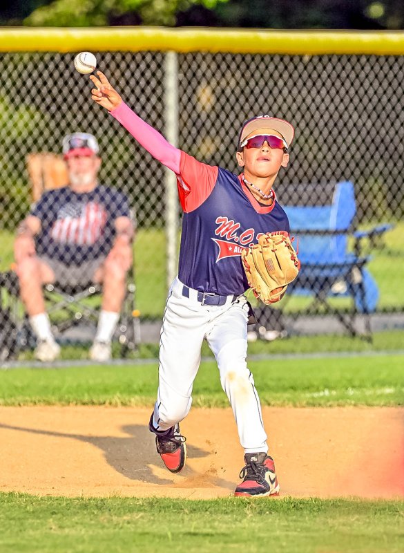 MOT third baseman Noah McFarland makes a long throw for an out.