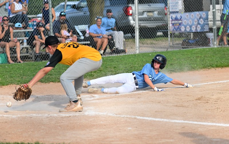 Lewes’ Jack Eanes slides safely into home.