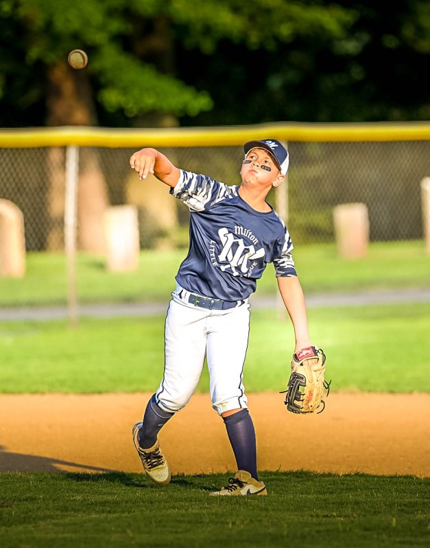 Milton third baseman Jase DeLacy throws to first for a put out.