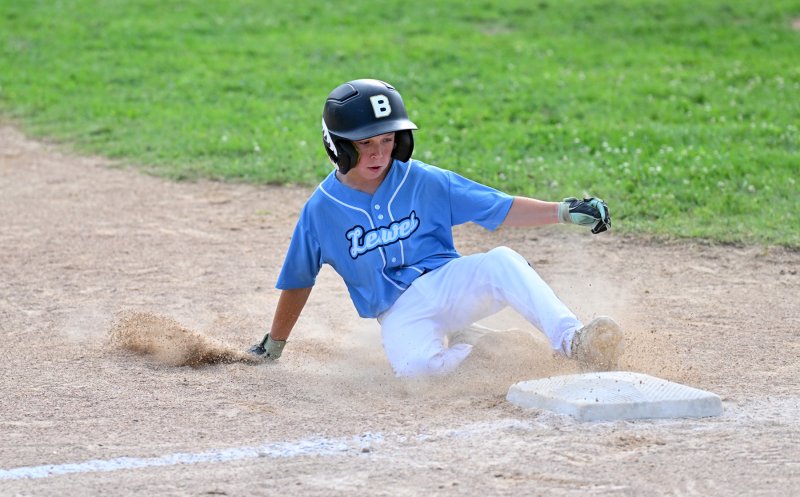 Shane Reynolds slides safely into third for Lewes.