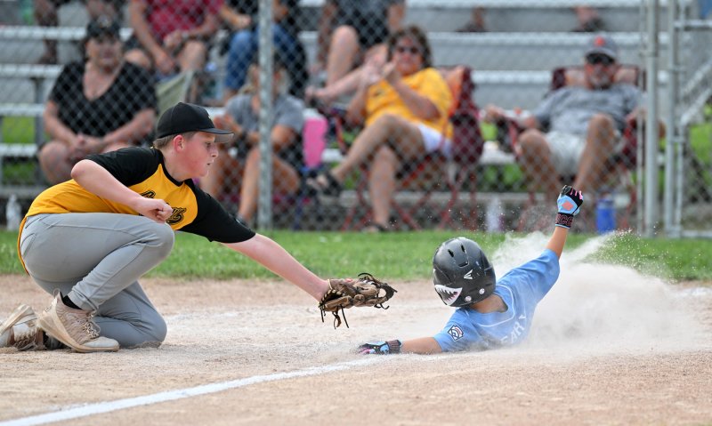 Georgetown pitcher Donald Leis makes a great effort, but just misses the tag on Lewes’ Conor Cleary.