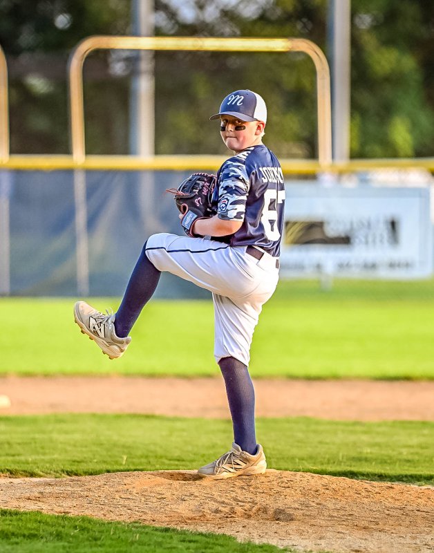 Milton starting pitcher Krew Johnson winds and delivers to the plate.
