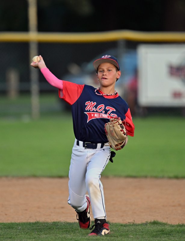 MOT’s Noah McFarland throws to first for a put out.