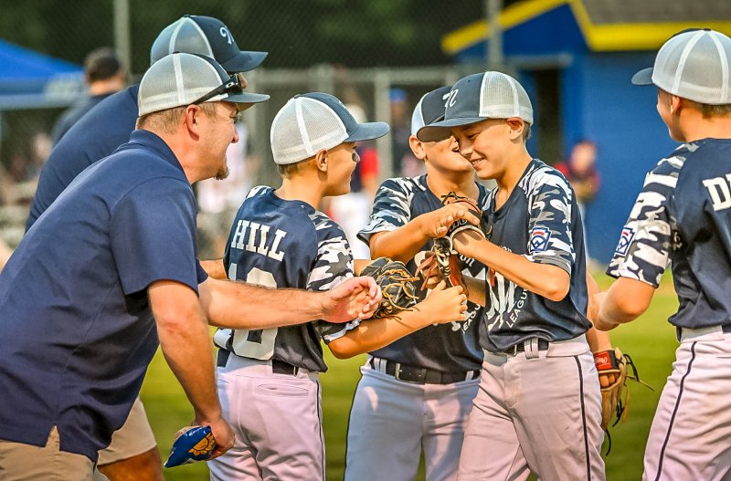 The Milton squad congratulates Jaxon Kulp on his defensive prowess.