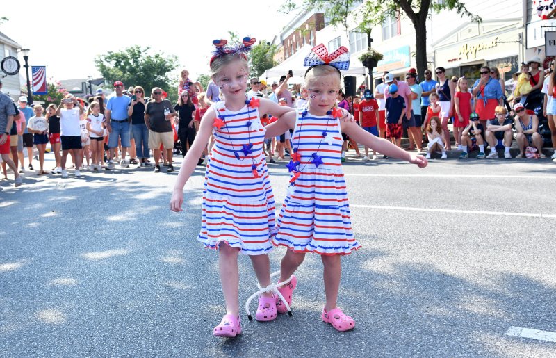Maeve Lynch, 6, and her sister Quinn, 5, finish up the three-legged race at the annual old-fashioned games.