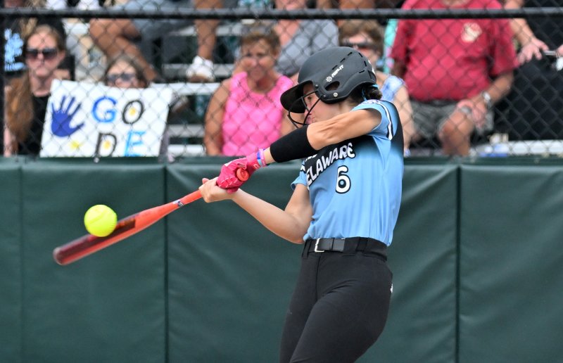 Delaware’s Taylor Lowe slams a triple in the game.