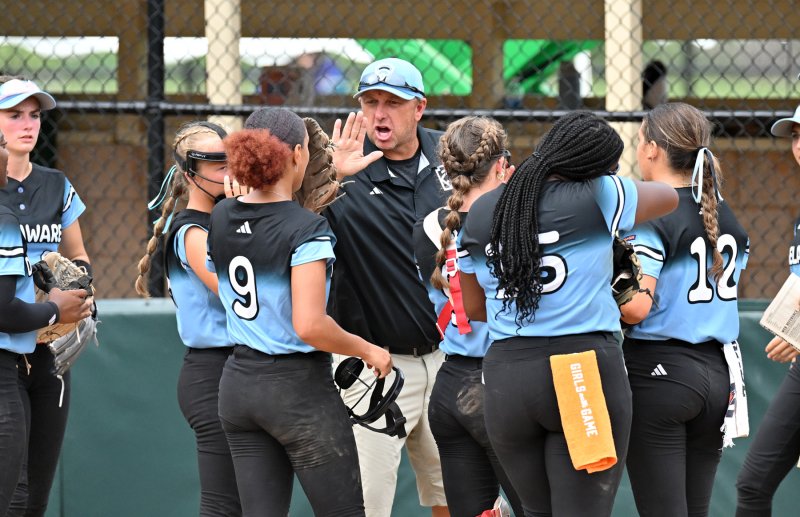 Delaware assistant coach Paul Kruger gets his players pumped coming in to bat in the sixth inning.