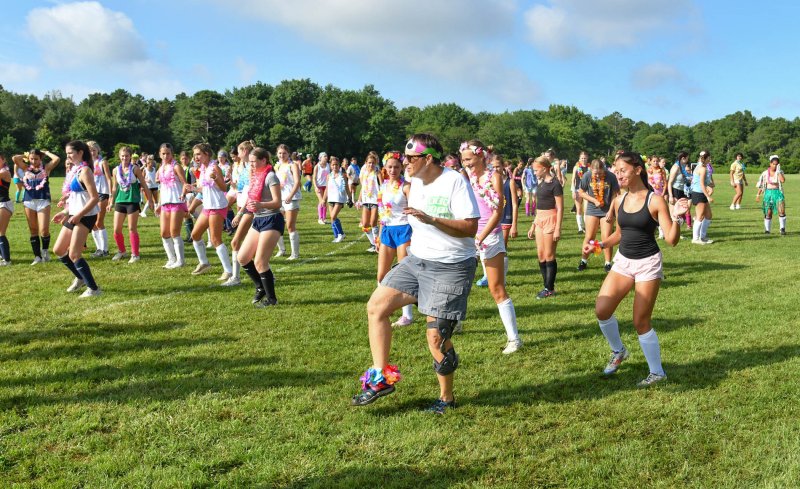 Mid-Atlantic Field Hockey Camp owner Frannie Slabonik leads the warmup dances.