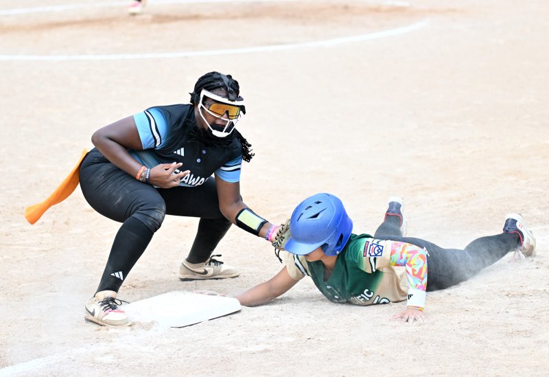 Delaware third baseman Jordynn Bowe keeps Asia-Pacific’s Julie Ann Buenafe honest at third base.