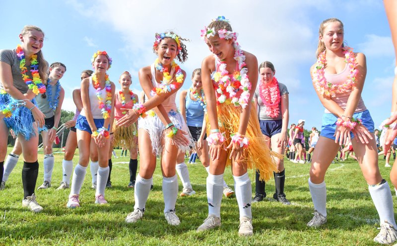 Campers Taylor Elshami and Alexandra Gummel, center, lead their group in the warmup dances.