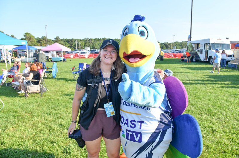 Petey the Coast TV mascot gives a hug to Hannah Jones during the event.