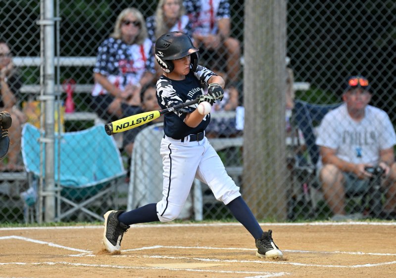 Milton’s Wyatt Dean slams one into the outfield.