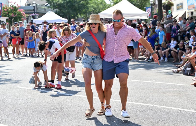 Shea, left, and MacKenzie Hay speed down Scond Street in the adult three-legged race.