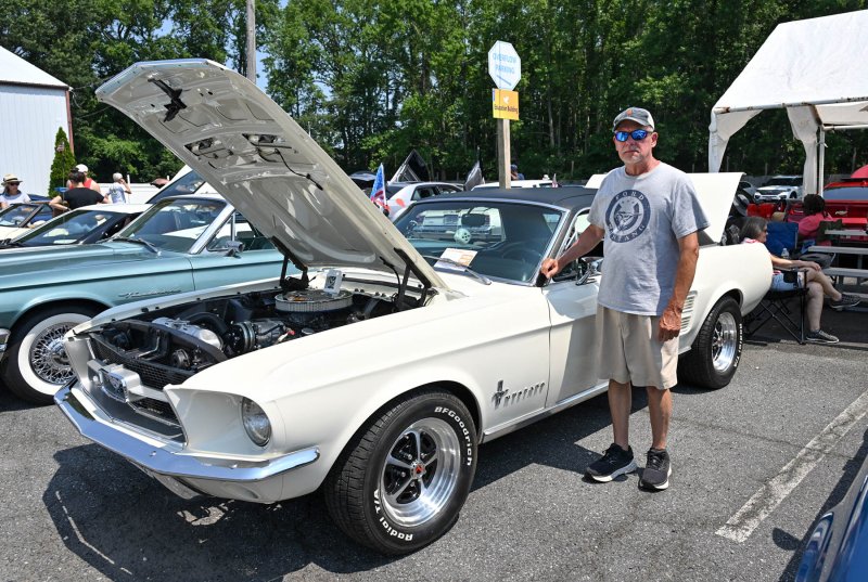 Eric Hertzog of Lewes stands with his classic 1966 Mustang.