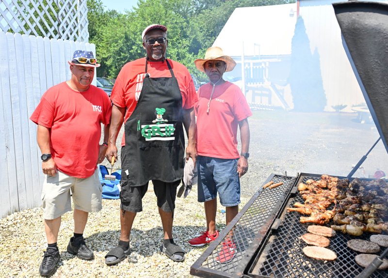 That’s good smoke coming off the grill at Trinity Faith Christian Center’s Fourth of July celebration. Shown are chefs (l-r) Clarence Harmon, Lloyd Griffin and Leon Treherne. DAN COOK PHOTOS
