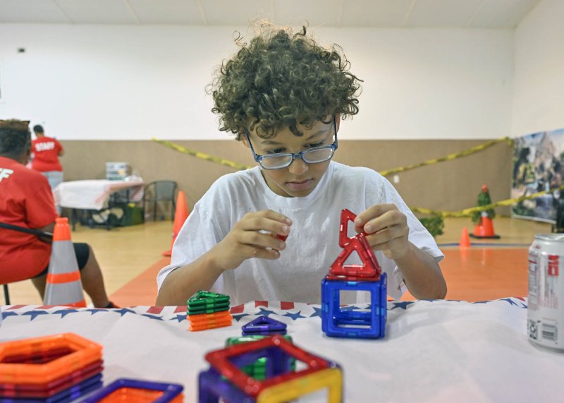 Talon Albitz, 12, plays Connect 4 at the kids’ fun room of the Trinity Faith Christian Center.