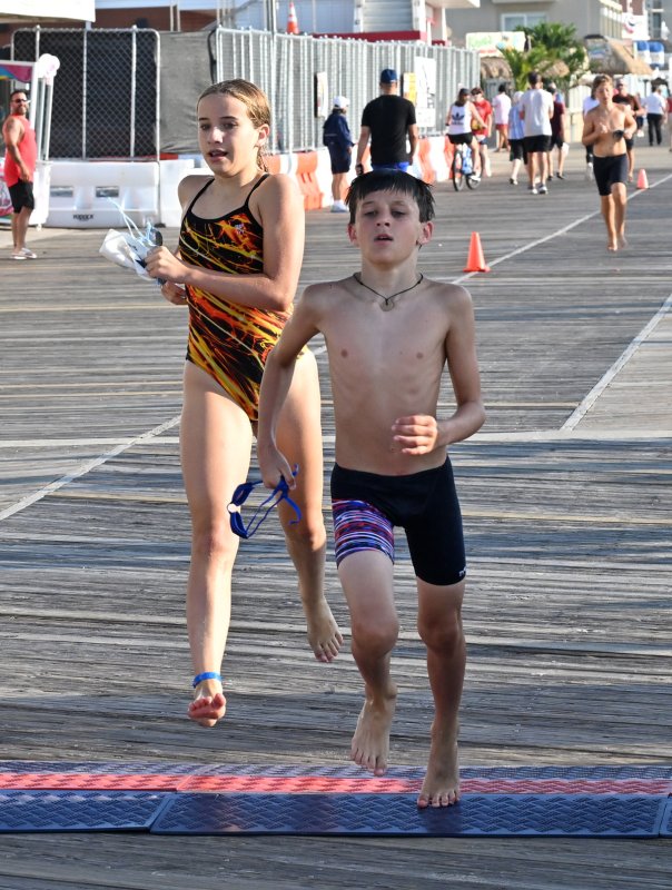 Cooper Adams, right, takes first, just ahead of Eliza Evans in the kids’ biathlon.