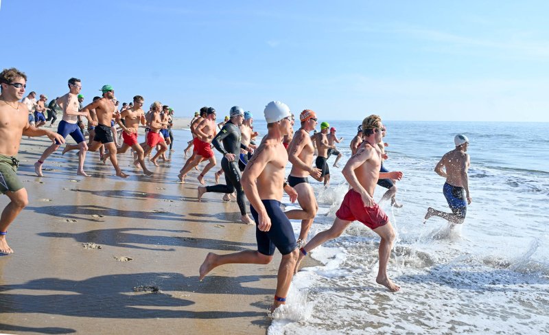 The open male division hits the surf at the start.