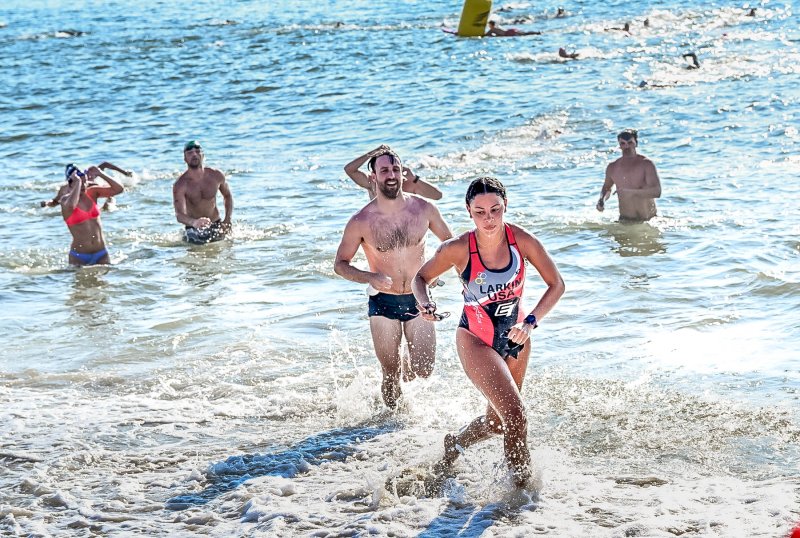 Female overall winner Ava Larkin leads a group out of the surf.