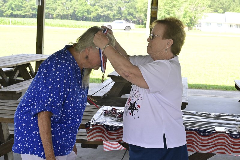 Dorothy “Dottie” LeCates is presented with the first-place ribbon and award for most patriotic attire by June Jones, president of American Legion Auxiliary Unit 28.