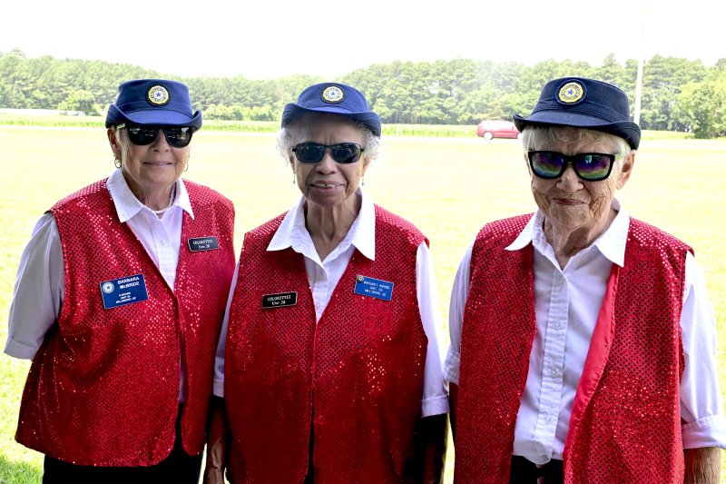 The color guard, formerly known as the Colorettes, is proudly represented by (l-r) Barbara McBride, Margaret Hopkins and Darlene Haus.