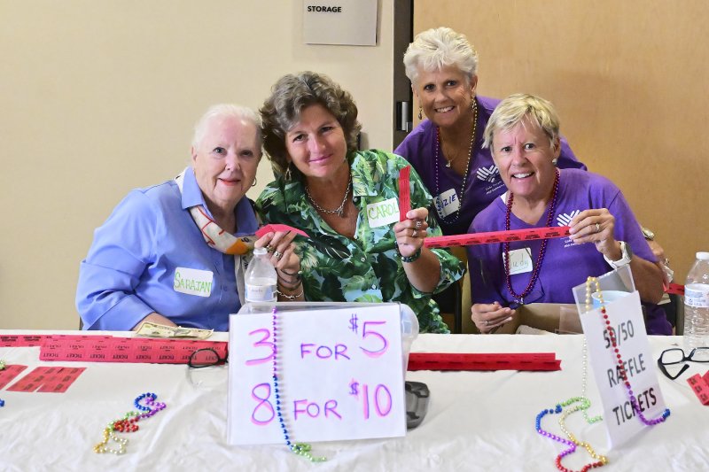 Sarajane Quinn, Carol Lee Thompson, Suzie Cannon and Judy Stout work the 50/50 table.