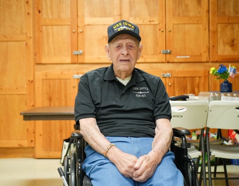 Raymond Sproul dons a U.S.S. Iowa hat and shirt at his 100th birthday party at the American Legion Post 28 near Millsboro July 19. ELLEN MCINTYRE PHOTOS