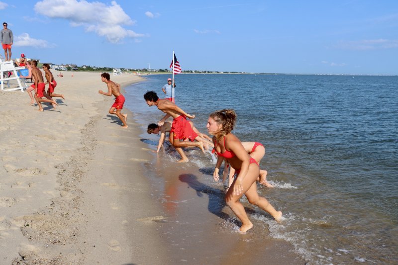 The rookie Lewes lifeguards doing line charges, part of the fourth annual rookie lifeguard competition on Johnnie Walker Beach July 23. It was one of four events in the competition.