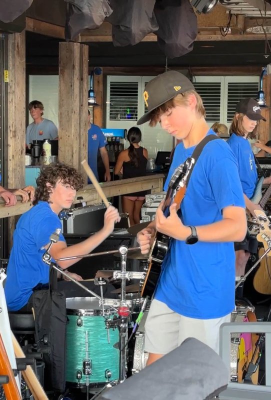 Aidan Clark plays the drums while Reed Snyder plays the guitar.