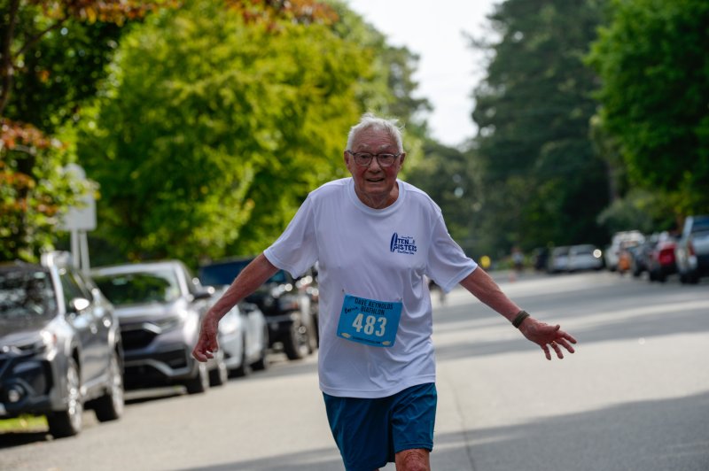 Bernie Gallagher, 84, breaks the imaginary tape at the Strider 5-Miler. DAVE FREDERICK PHOTOS