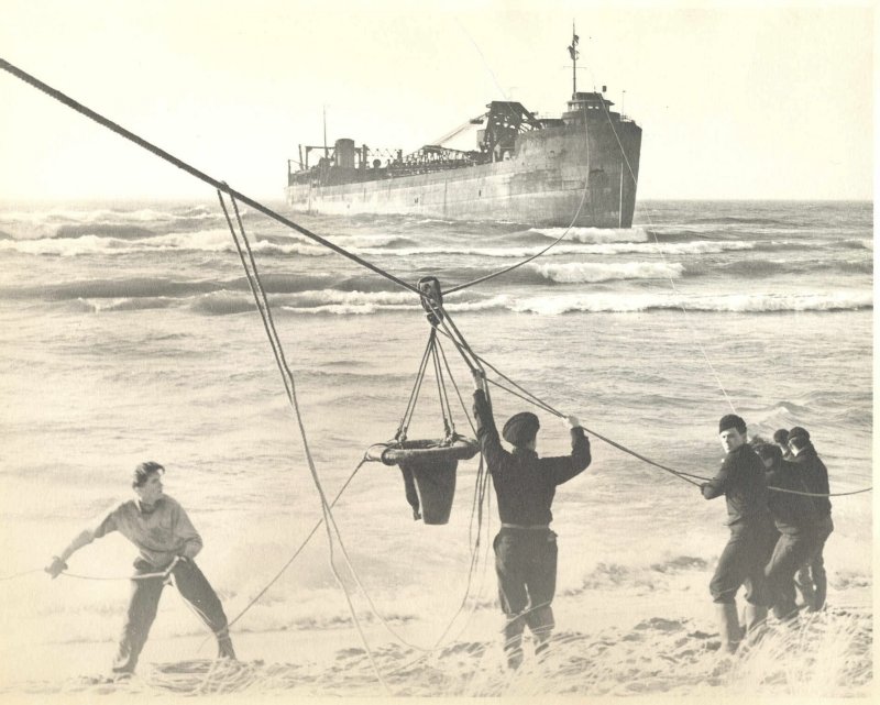 Surfmen use a breeches buoy to rescue people off a ship. SAVIORS OF THE SEA PHOTO