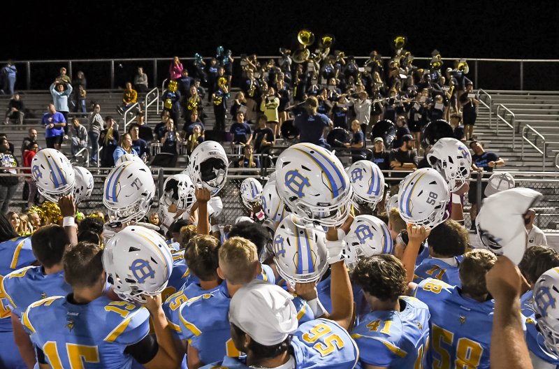 The team celebrates its victory by singing the alma mater with the Cape band.
