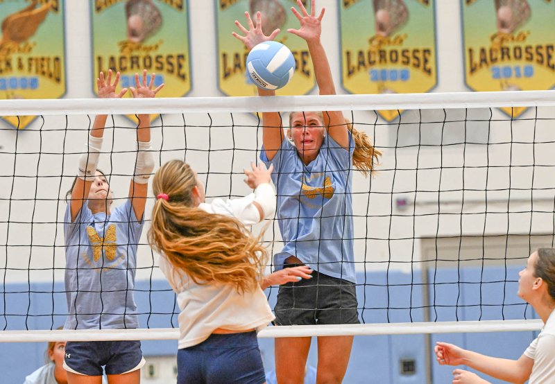 Cape’s Kaylee Sockriter, left, and Amalia Fruchtman go for a block on a Sussex Academy kill attempt. DAN COOK PHOTOS