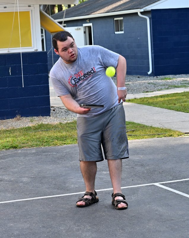Athlete Aaron Thompson throws up a lob in his pickleball game.
