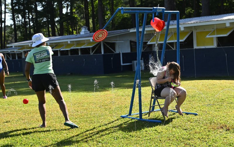 Counselor Regina Stevens pulls a fast one and soaks athlete Cailee Layton.