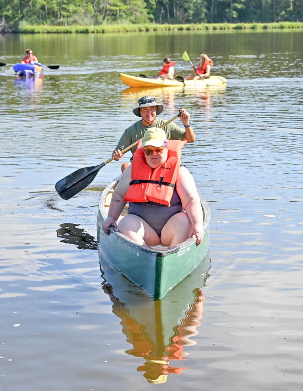 Athlete Pamela Brown guides counselor Danny Hall into the shore.