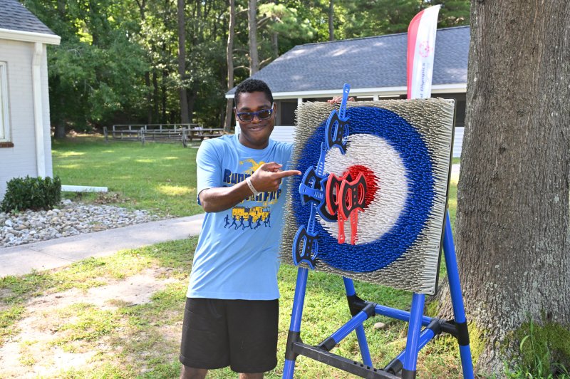 Athlete Daquan Taylor shows off his two bullseyes in the hatchet-throwing event.