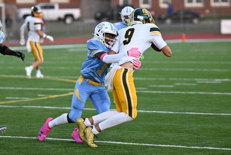 Cape senior defensive back Navin Duffy pulls down running back Maxwell Batten.