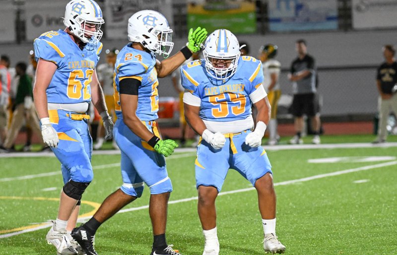 Cape freshman linebacker Javier Morales-Roblero, right, celebrates a tackle with teammates Liam Ramsey and Quardell Richards.
