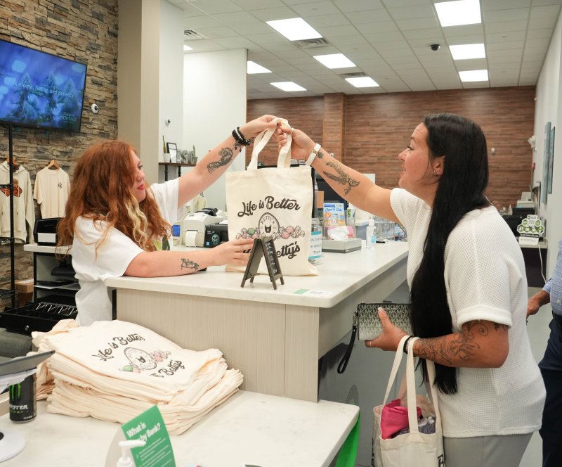Joyce McCarthy, right, is the first recreational cannabis customer at Thrive Dispensary’s Lewes location Aug. 1. She is helped by budtender Alexis Fullerton. ELLEN MCINTYRE PHOTOS