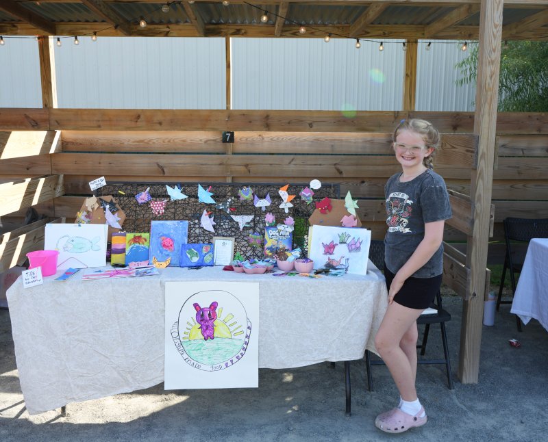 Rhozlyn Vogelsong, a fifth-grader at H.O. Brittingham Elementary, sells her origami, paintings and handmade bookmarks at her booth.