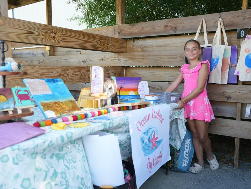 Ginny Woolsey, a fourth-grader at East Millsboro Elementary, sells a variety of colorful artwork at her booth, Ocean Galore by Ginny. She was part of the Developing Artist Collaboration’s Artist Rising end-of-summer showcase held Aug. 16 at the West Side Creative Market in Rehoboth Beach. ELLEN MCINTYRE PHOTOS