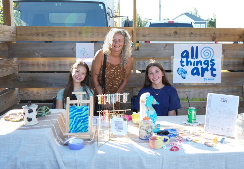 One of the Artist Rising ceramics instructors and DAC working artists, Millie Crotty, stops at two of her students’ booths to see their art on display. Shown with Crotty are (l-r) eighth-graders Clara Downes and Nina Pollard.
